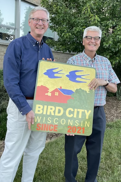 Jeff Roznowski holding bird city sign